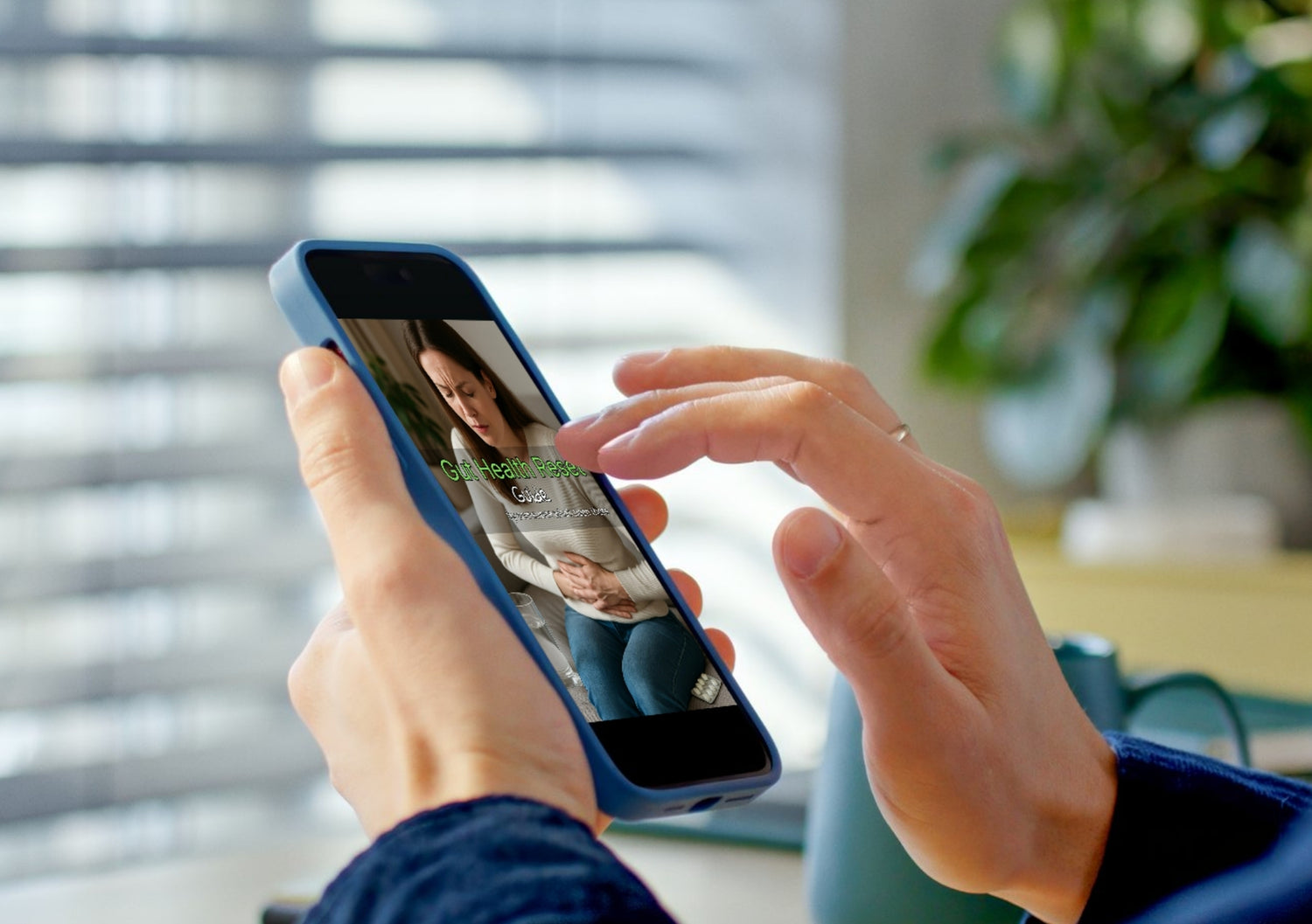 Person holding a smartphone with a gut health reset guide on the screen, blurred background