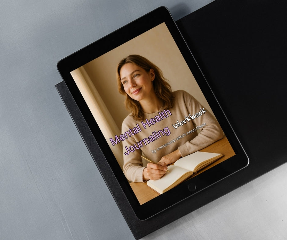 Tablet displaying a digital version of a 'Mental Health Journaling Workbook' on a gray surface.